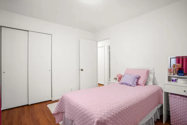 a bedroom with a bed and a book shelf