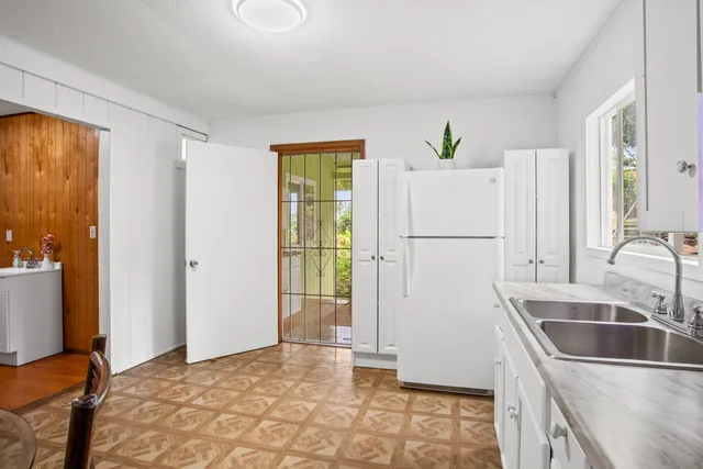 a kitchen with a refrigerator and a sink