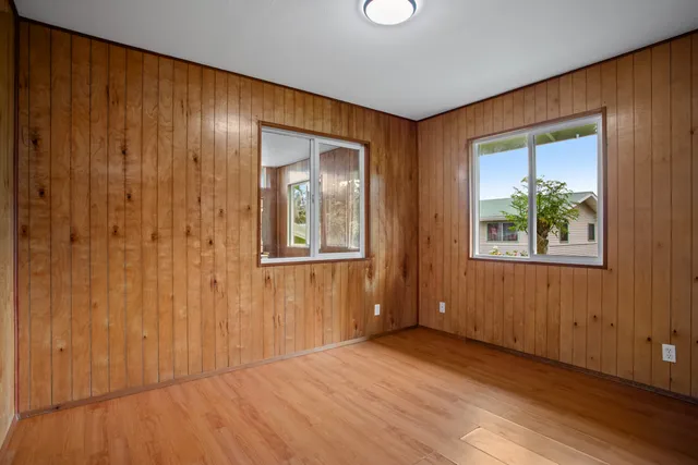 an empty room with windows and closet