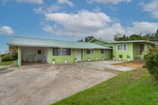 a view of a house with a yard and plants