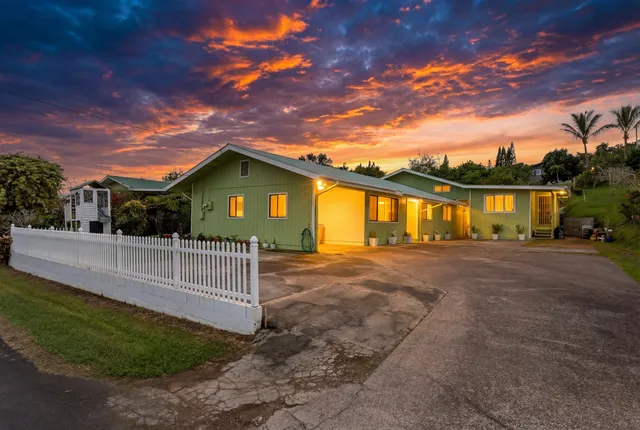 a view of a house with a backyard