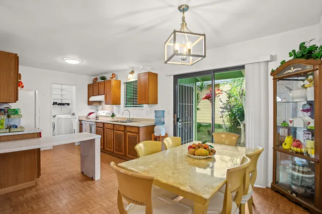a view of a dining room with furniture a chandelier and wooden floor