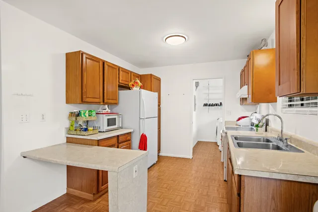 a kitchen that has a sink and a refrigerator
