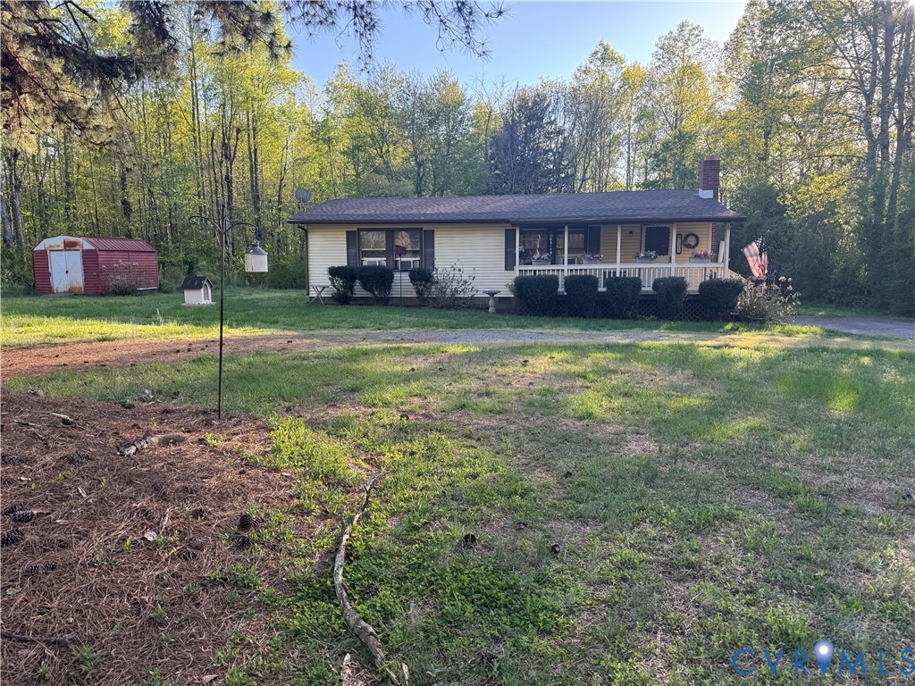 1313 Poplar Lawn Road Blackstone, VA 23824 - Photo 1 of 26 a front view of a house with a yard