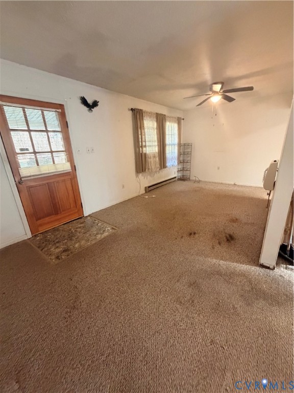 1313 Poplar Lawn Road Blackstone, VA 23824 - Photo 4 of 26 an empty room with windows and entrance
