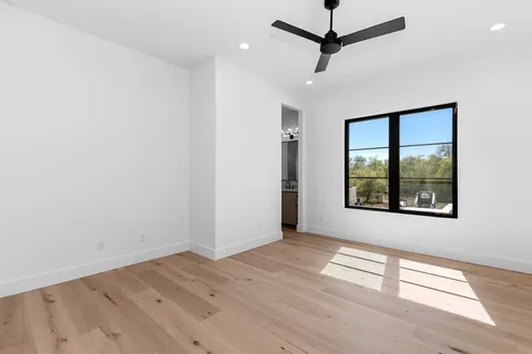 a large kitchen with stainless steel appliances a sink a counter space and a window