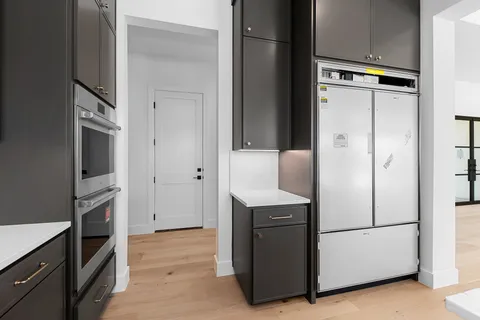 a kitchen with stainless steel appliances granite countertop a stove and a refrigerator