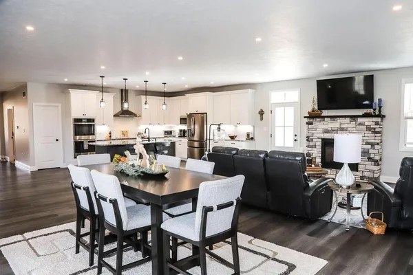 a spacious bathroom with a double vanity sink a toilet a mirror and shower