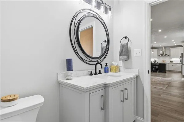 a front view of a house with yard and trees in the background