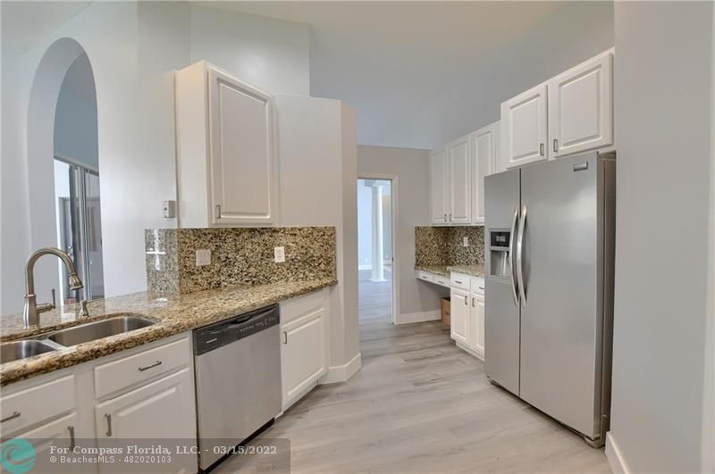 Boca Falls Boca Raton, FL 33428 - Photo 19 of 40 a kitchen with granite countertop a refrigerator and a sink