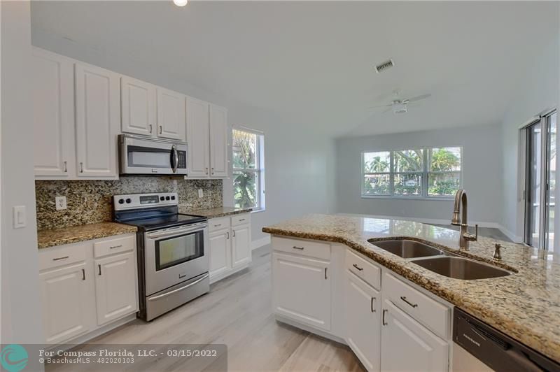 Boca Falls Boca Raton, FL 33428 - Photo 20 of 40 a kitchen with granite countertop white cabinets white stainless steel appliances and a sink