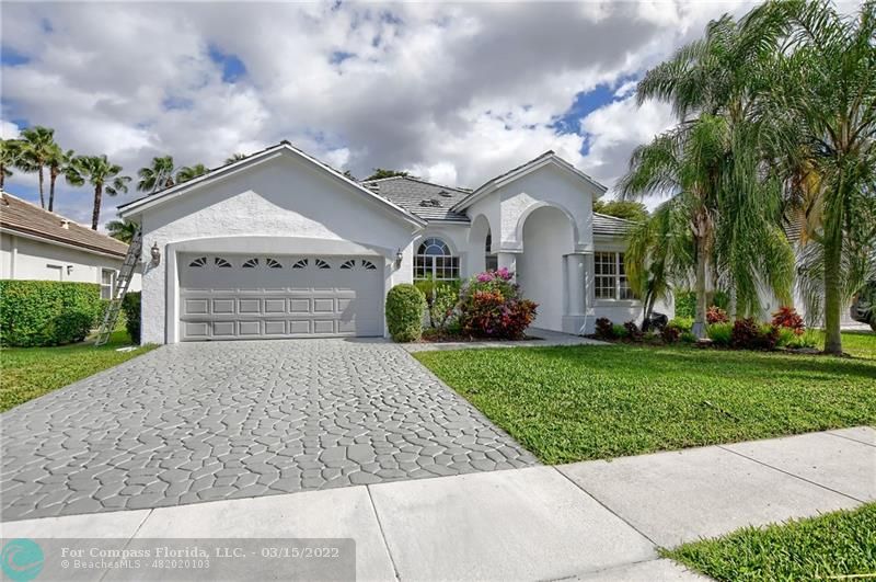 Boca Falls Boca Raton, FL 33428 - Photo 2 of 40 front view of a house with a yard