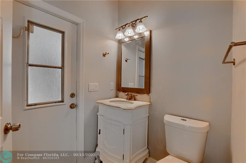Boca Falls Boca Raton, FL 33428 - Photo 22 of 40 a bathroom with a sink a toilet a mirror and shower