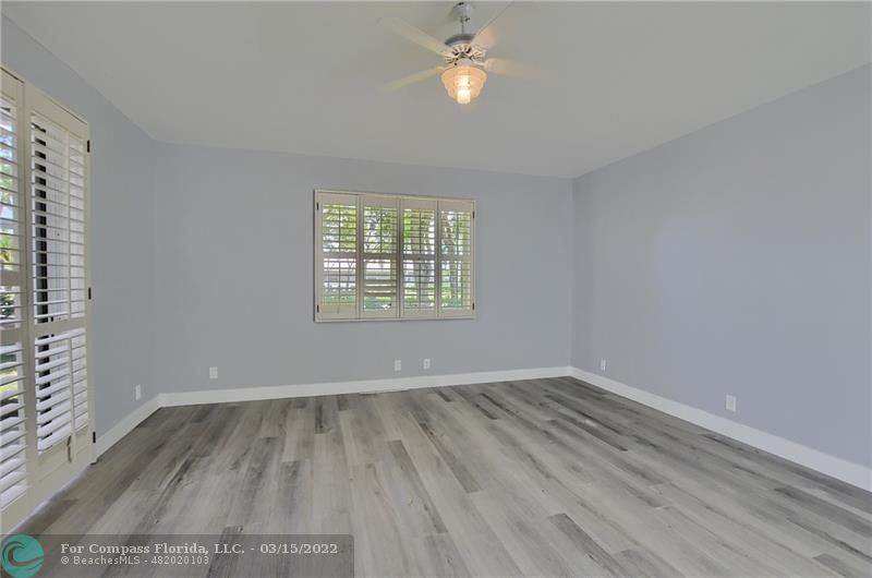 Boca Falls Boca Raton, FL 33428 - Photo 24 of 40 an empty room with wooden floor and windows