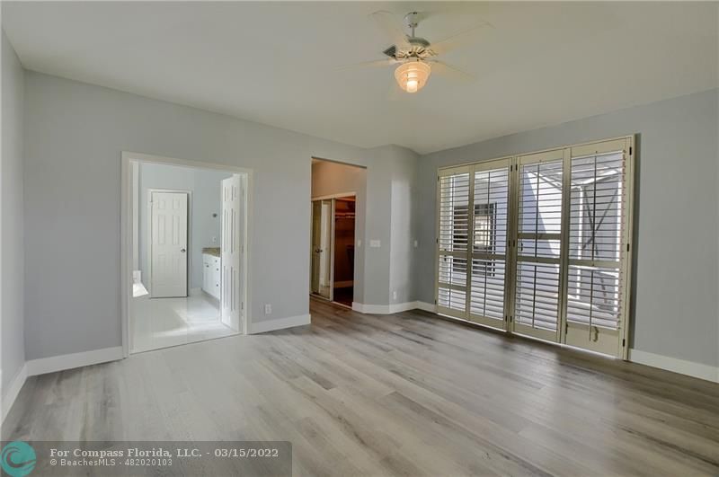 Boca Falls Boca Raton, FL 33428 - Photo 25 of 40 an empty room with wooden floor and windows