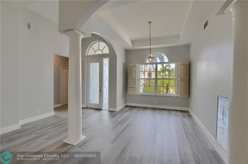 Boca Falls Boca Raton, FL 33428 - Photo 6 of 40 a view of a room with wooden floor chandelier and a window