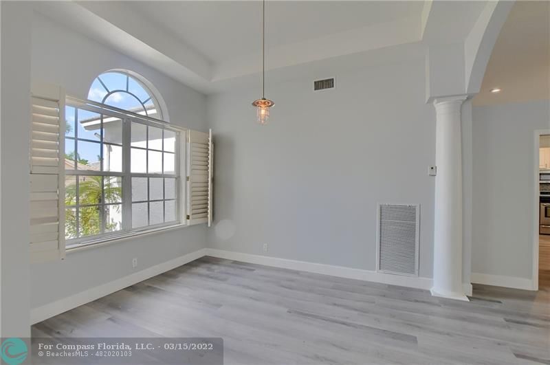 Boca Falls Boca Raton, FL 33428 - Photo 8 of 40 an empty room with wooden floor cabinet and windows