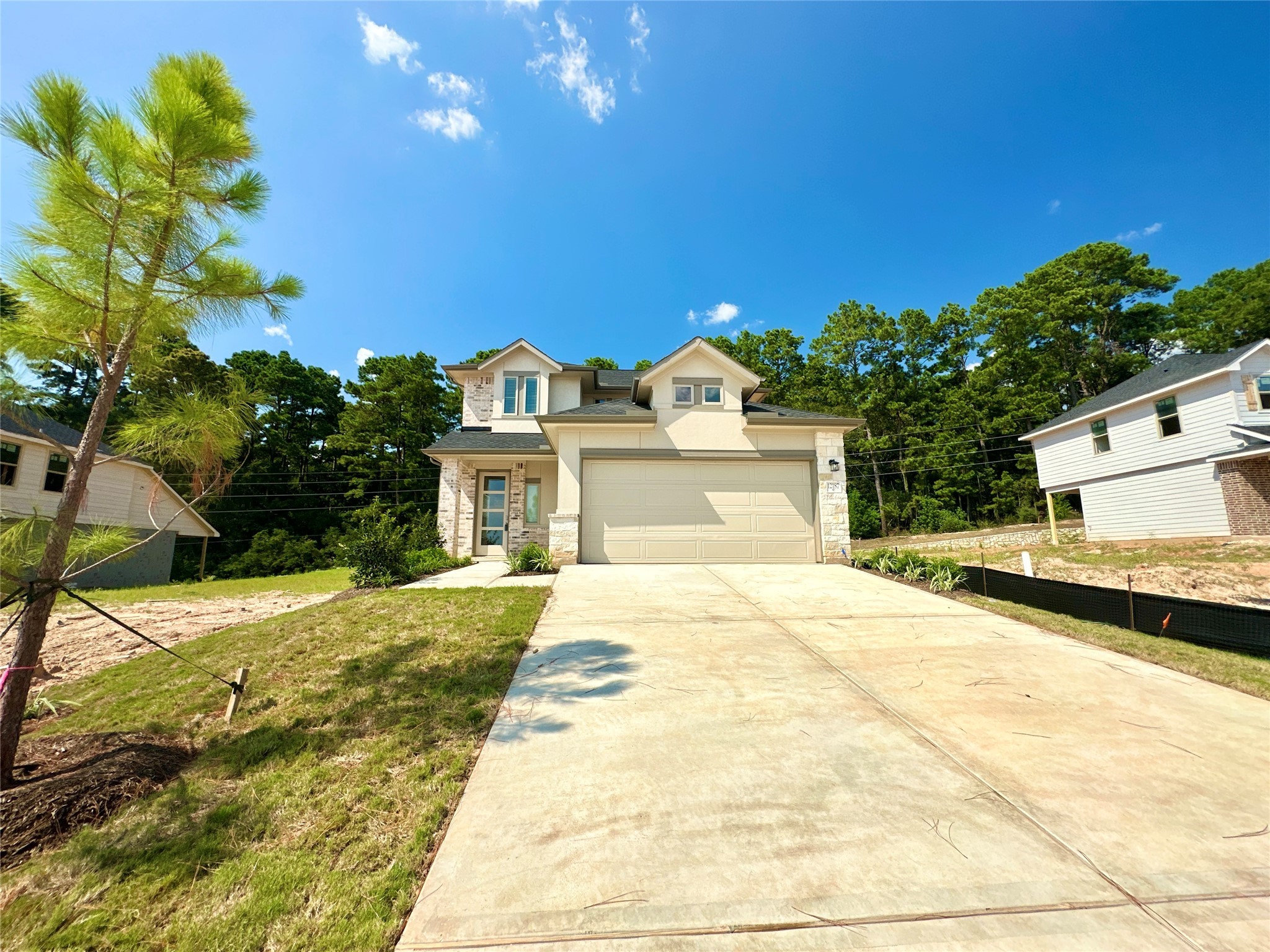12187 Ridge Top Drive Conroe, TX 77304 - Photo 2 of 26 a front view of a house with a yard