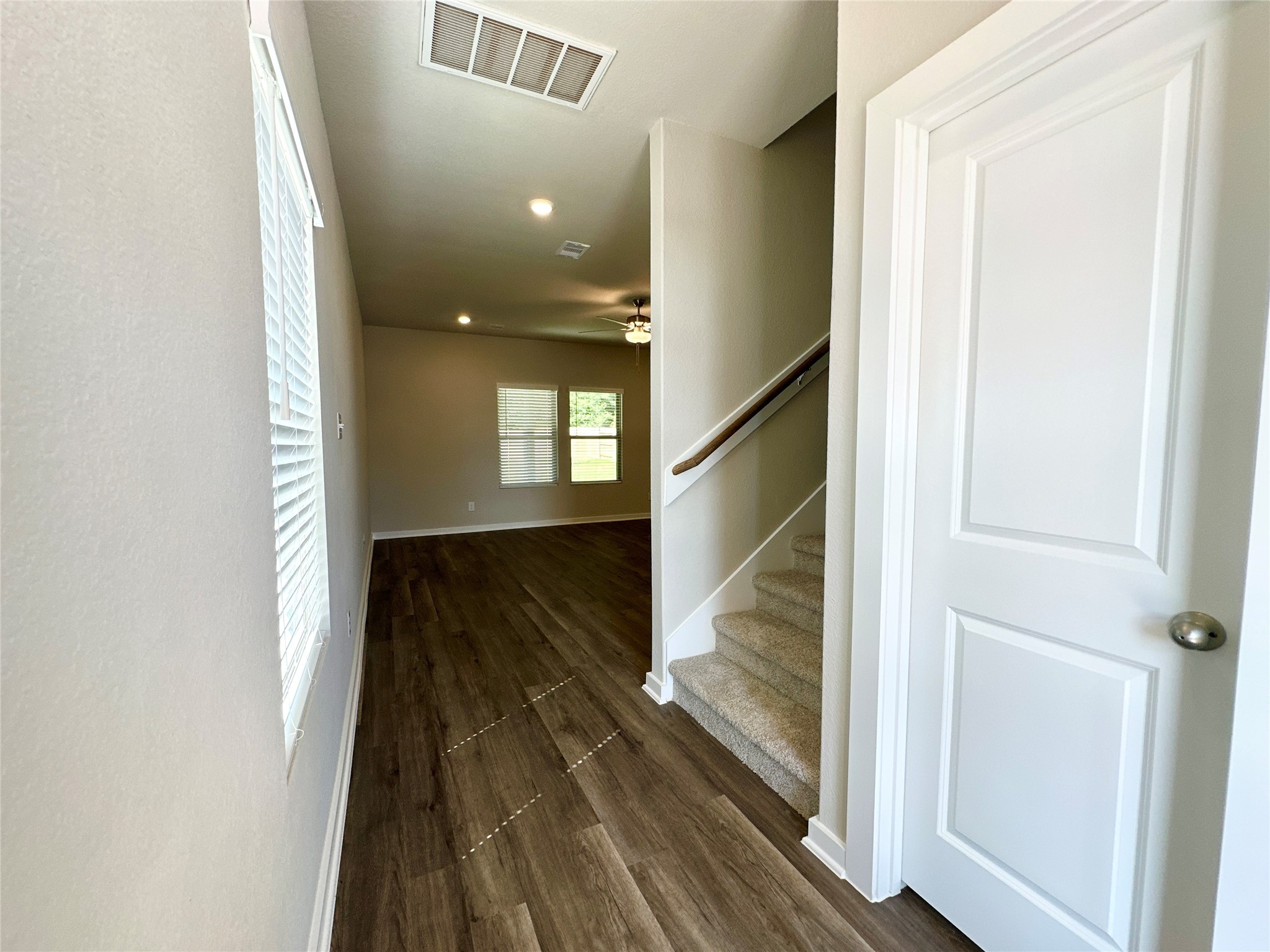 12187 Ridge Top Drive Conroe, TX 77304 - Photo 3 of 26 a view of a hallway with wooden floor and staircase