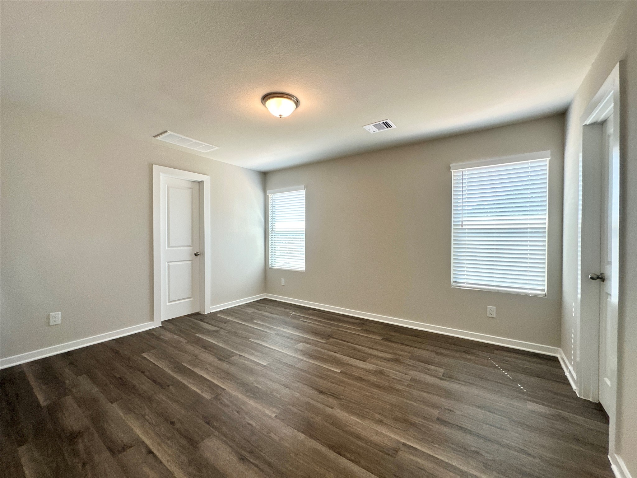 12187 Ridge Top Drive Conroe, TX 77304 - Photo 8 of 26 a view of an empty room with wooden floor and a window