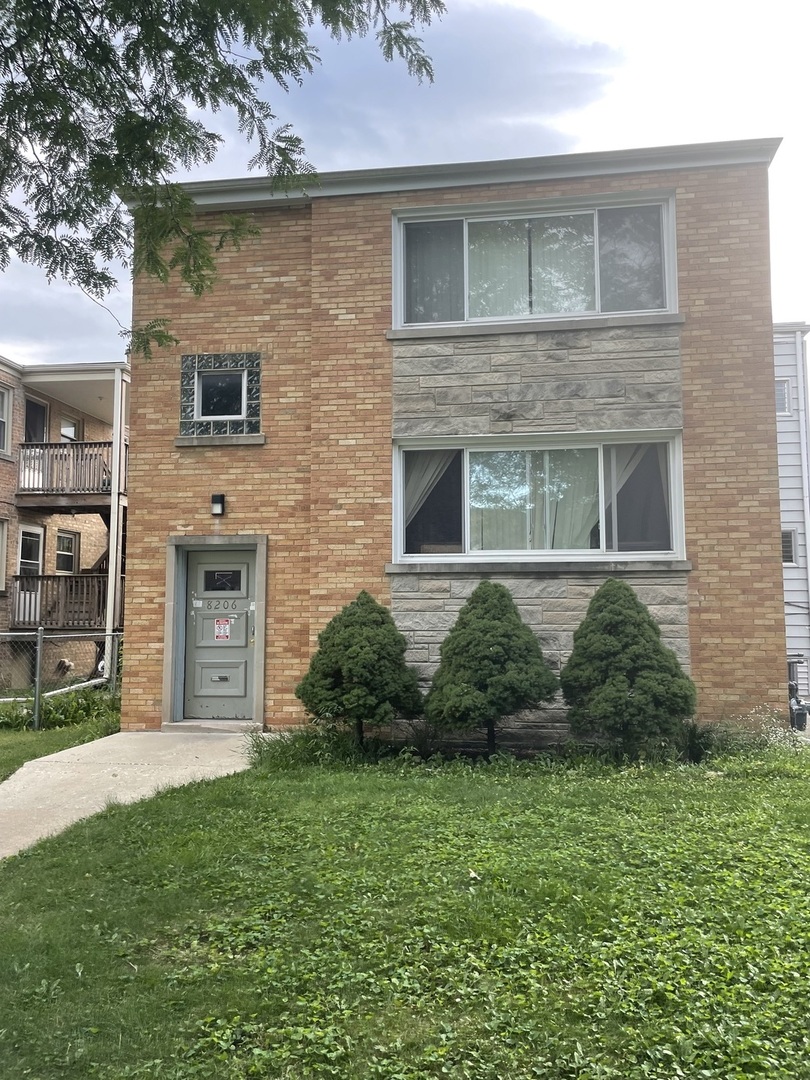 8206 Kilpatrick Avenue Skokie, IL 60076 - Photo 2 of 5 a view of a brick house with a yard and large windows