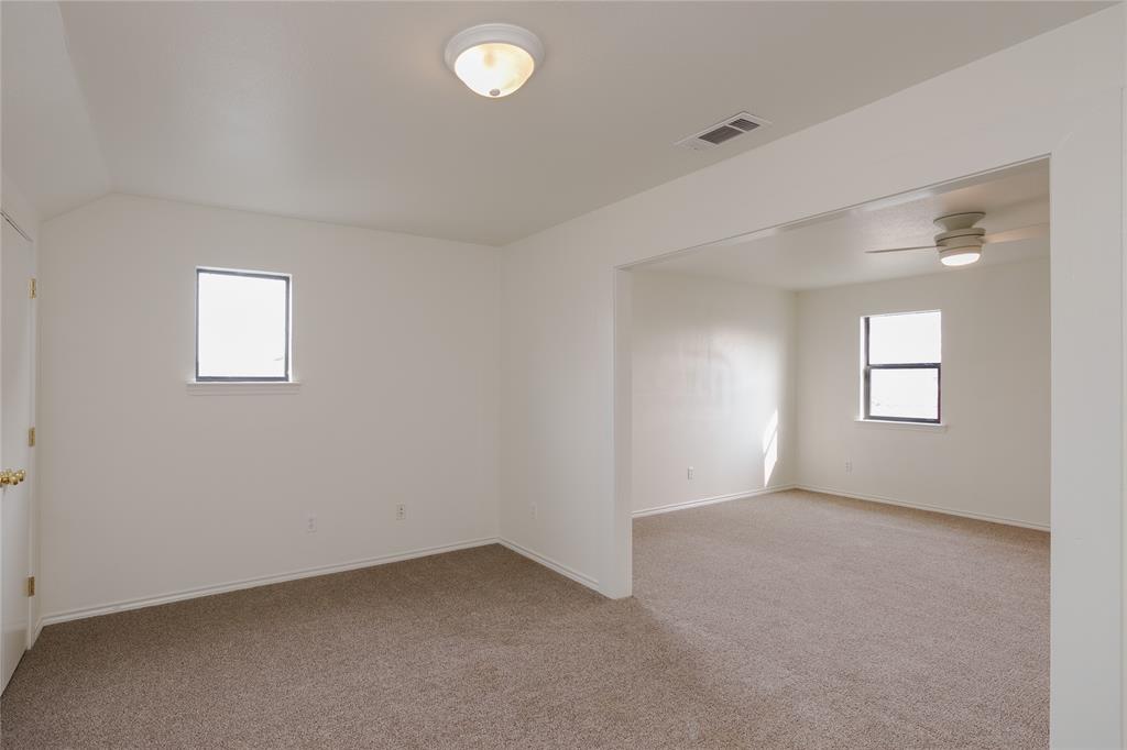 364 Parker Road, Unit A Van Alstyne, TX 75495 - Photo 30 of 39 Upstairs second primary suite with Two distinct areas giving this bedroom a living suite as well as attached bathroom is great for multi generational living.l featuring neutral-toned carpeting and white walls