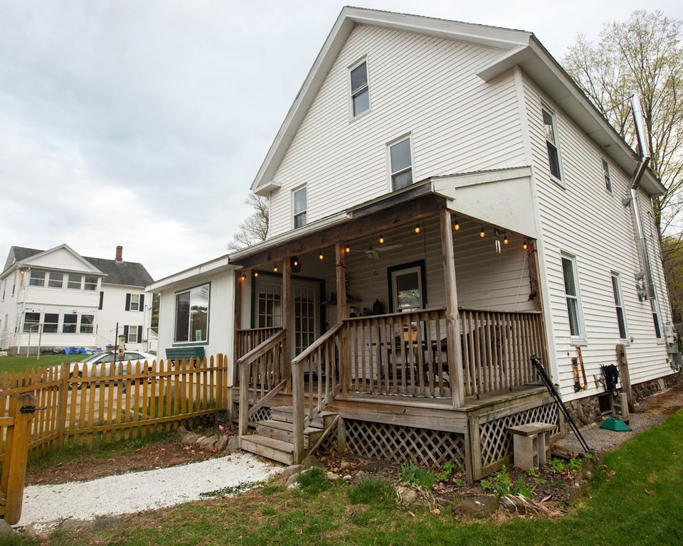9 Clinton Street Ware, MA 01082 - Photo 17 of 25 a view of a house with a small yard and wooden deck