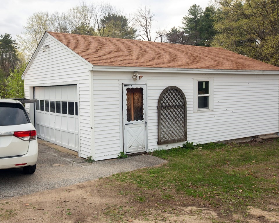 9 Clinton Street Ware, MA 01082 - Photo 3 of 25 a view of a white house with a yard and garage