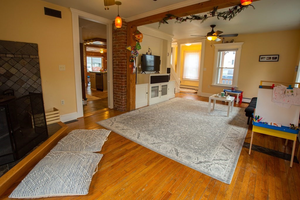 9 Clinton Street Ware, MA 01082 - Photo 8 of 25 a living room with stainless steel appliances kitchen island granite countertop furniture and a fireplace