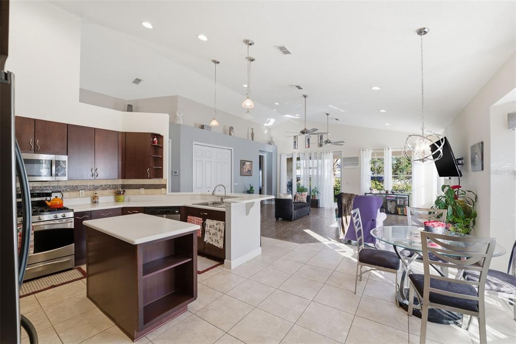 1733 West Caroline Path Lecanto, FL 34461 - Photo 11 of 29 a kitchen with kitchen island a stove a sink a oven a dining table and chairs