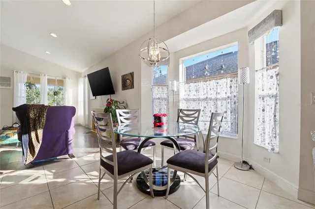 a room with furniture a chandelier and a flat screen tv
