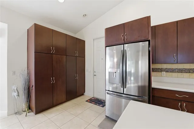 a kitchen with a refrigerator and a sink