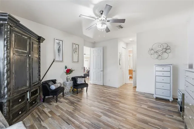 a view of a workspace with furniture and wooden floor