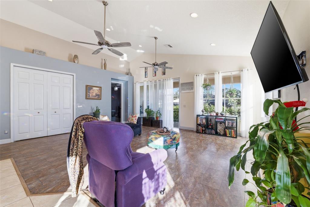 1733 West Caroline Path Lecanto, FL 34461 - Photo 6 of 29 a living room with furniture a chandelier and a flat screen tv