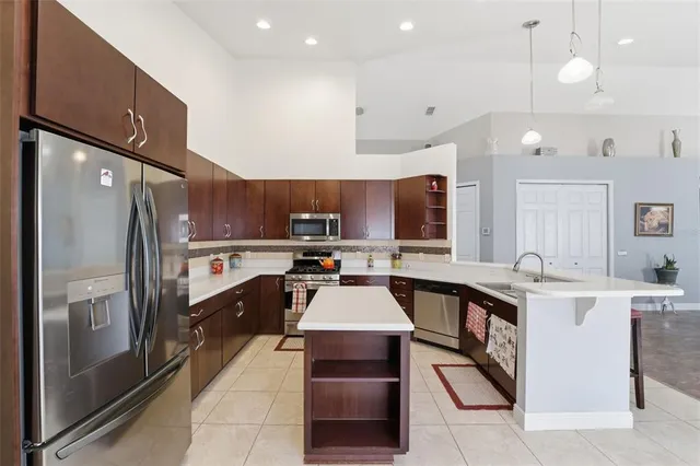 a large kitchen with stainless steel appliances lots of counter space and a refrigerator