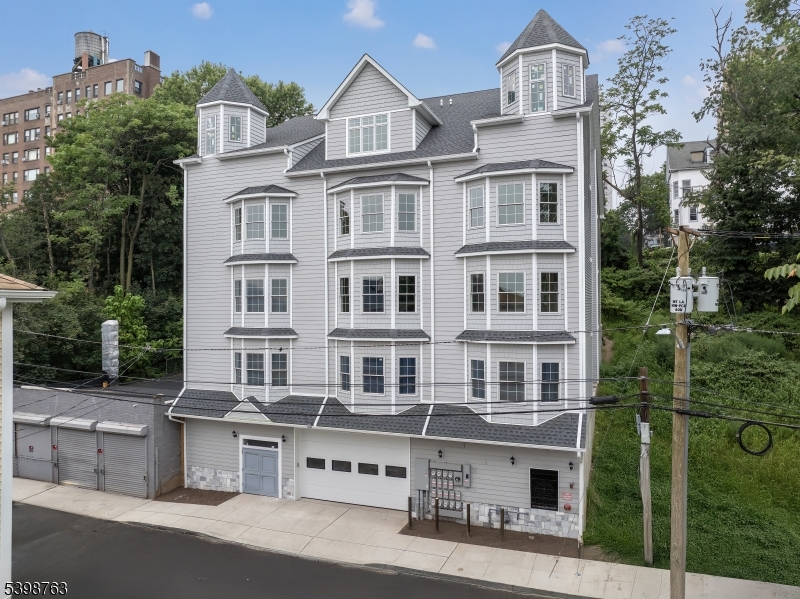 60 Woodside Place, Unit 4C Newark, NJ 07104 - Photo 14 of 14 a front view of a residential apartment building with a yard