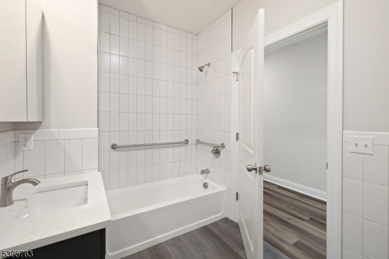 60 Woodside Place, Unit 4C Newark, NJ 07104 - Photo 7 of 14 a bathroom with a sink and a shower