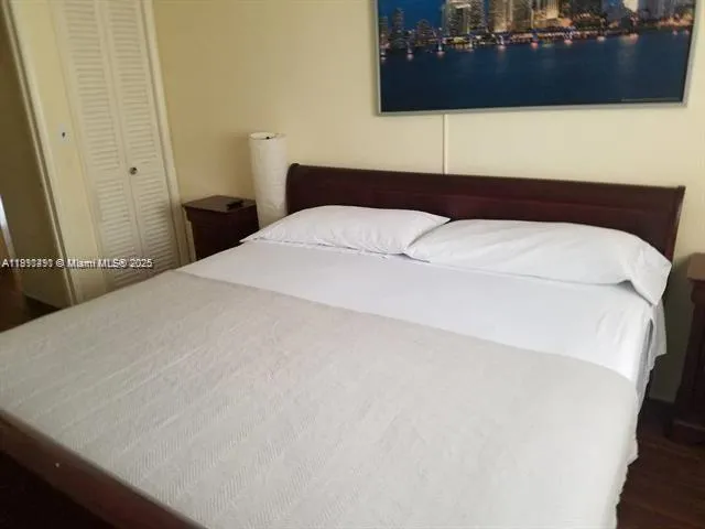 a bedroom with a bed and a mirror