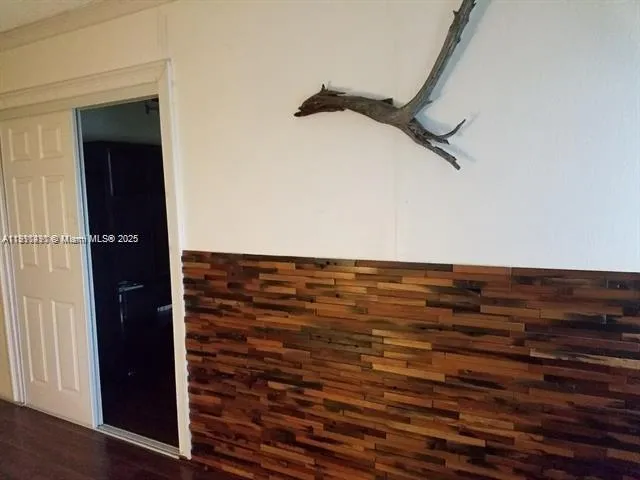 a living room with a wooden floor and a sink