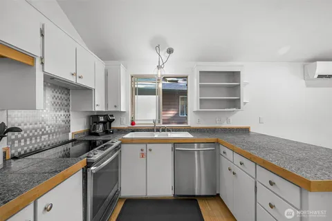 a kitchen with stainless steel appliances granite countertop a sink stove and cabinets