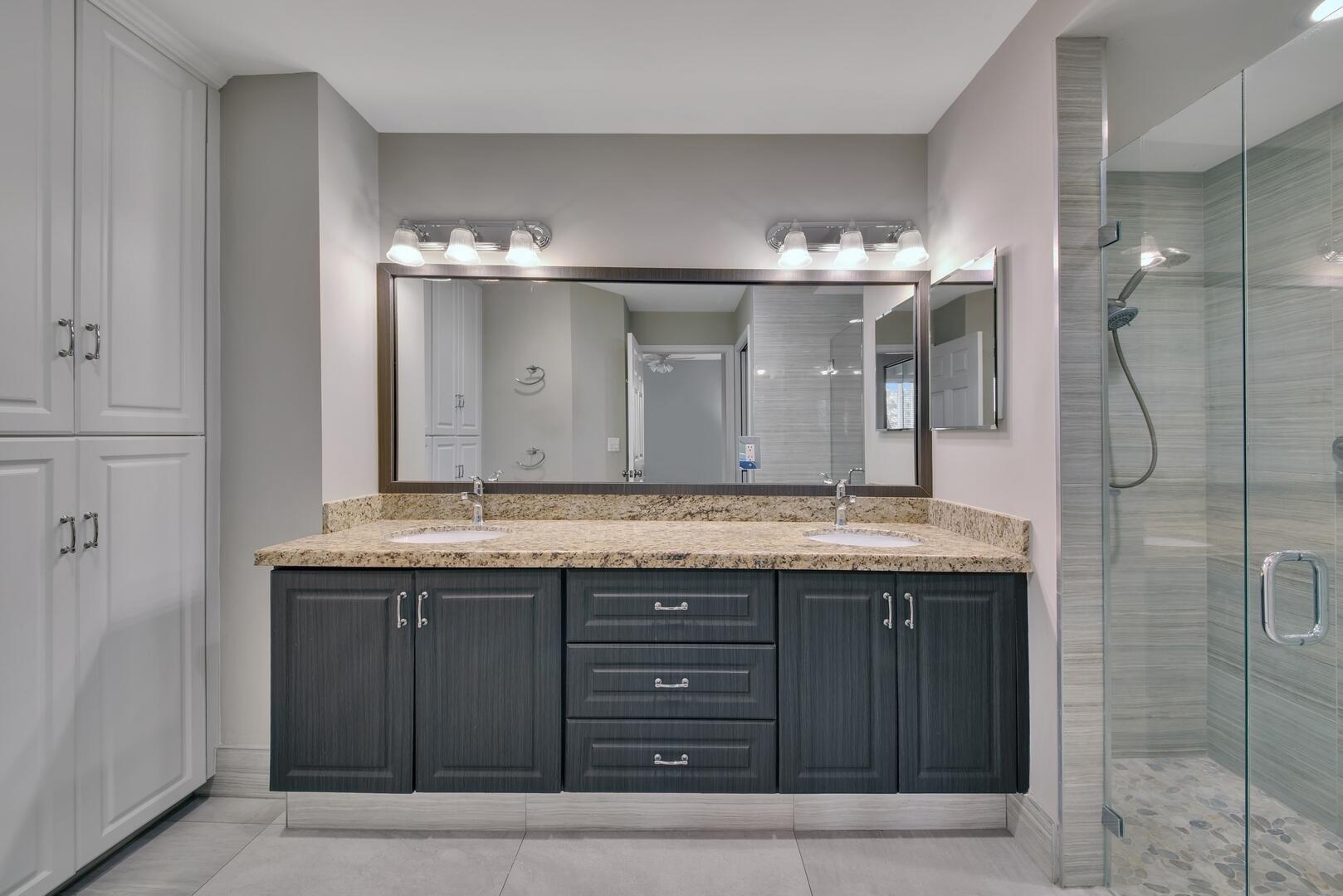 12438 Crystal Pointe Drive, Unit 102 Boynton Beach, FL 33437 - Photo 17 of 39 a bathroom with a granite countertop sink and a mirror