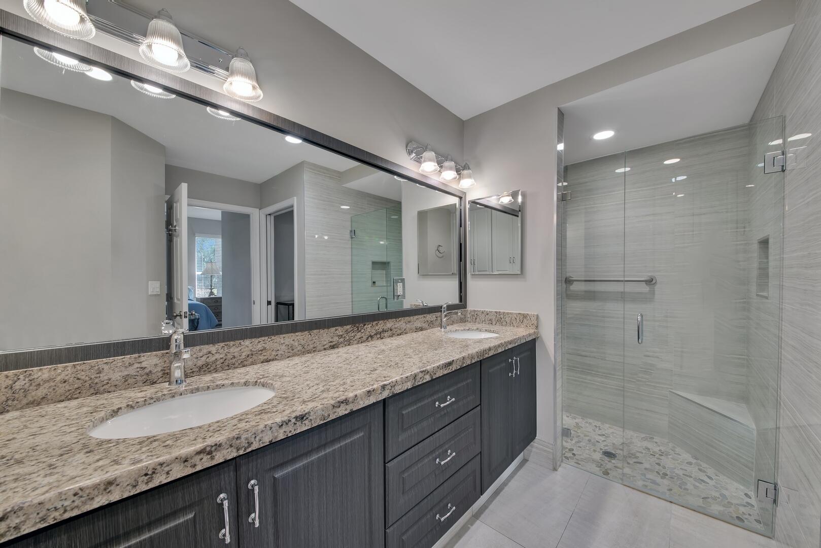 12438 Crystal Pointe Drive, Unit 102 Boynton Beach, FL 33437 - Photo 19 of 39 a bathroom with a granite countertop sink shower and a mirror