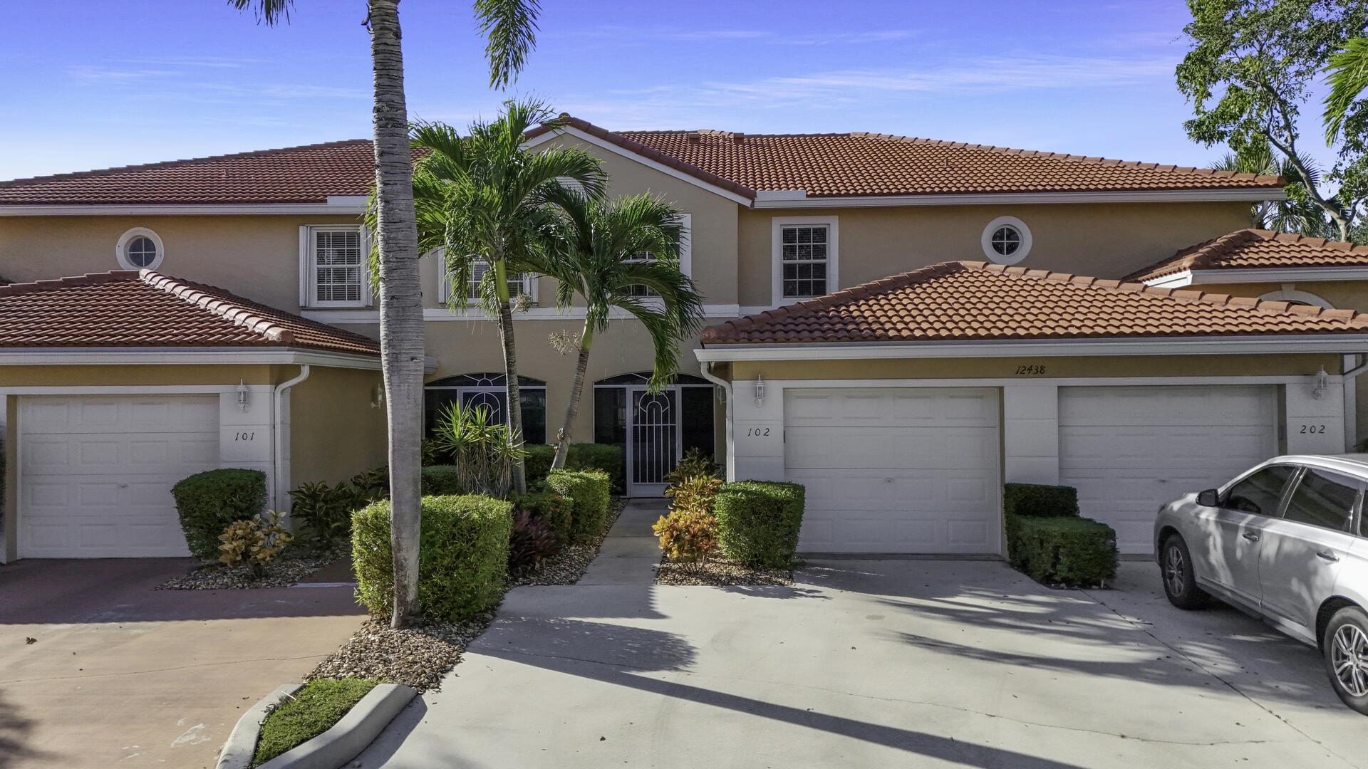 12438 Crystal Pointe Drive, Unit 102 Boynton Beach, FL 33437 - Photo 26 of 39 a front view of a house with garden