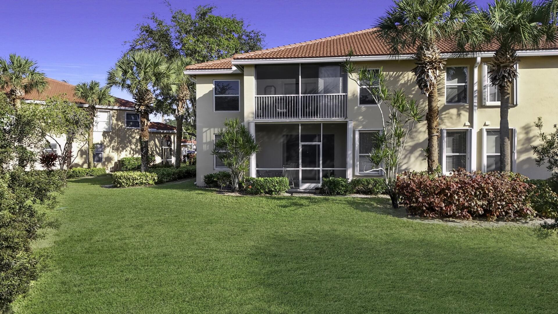 12438 Crystal Pointe Drive, Unit 102 Boynton Beach, FL 33437 - Photo 29 of 39 front view of a house with a yard
