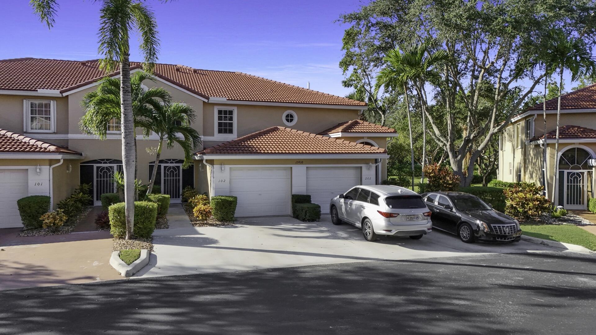 12438 Crystal Pointe Drive, Unit 102 Boynton Beach, FL 33437 - Photo 34 of 39 a view of a patio with couches and a fire pit