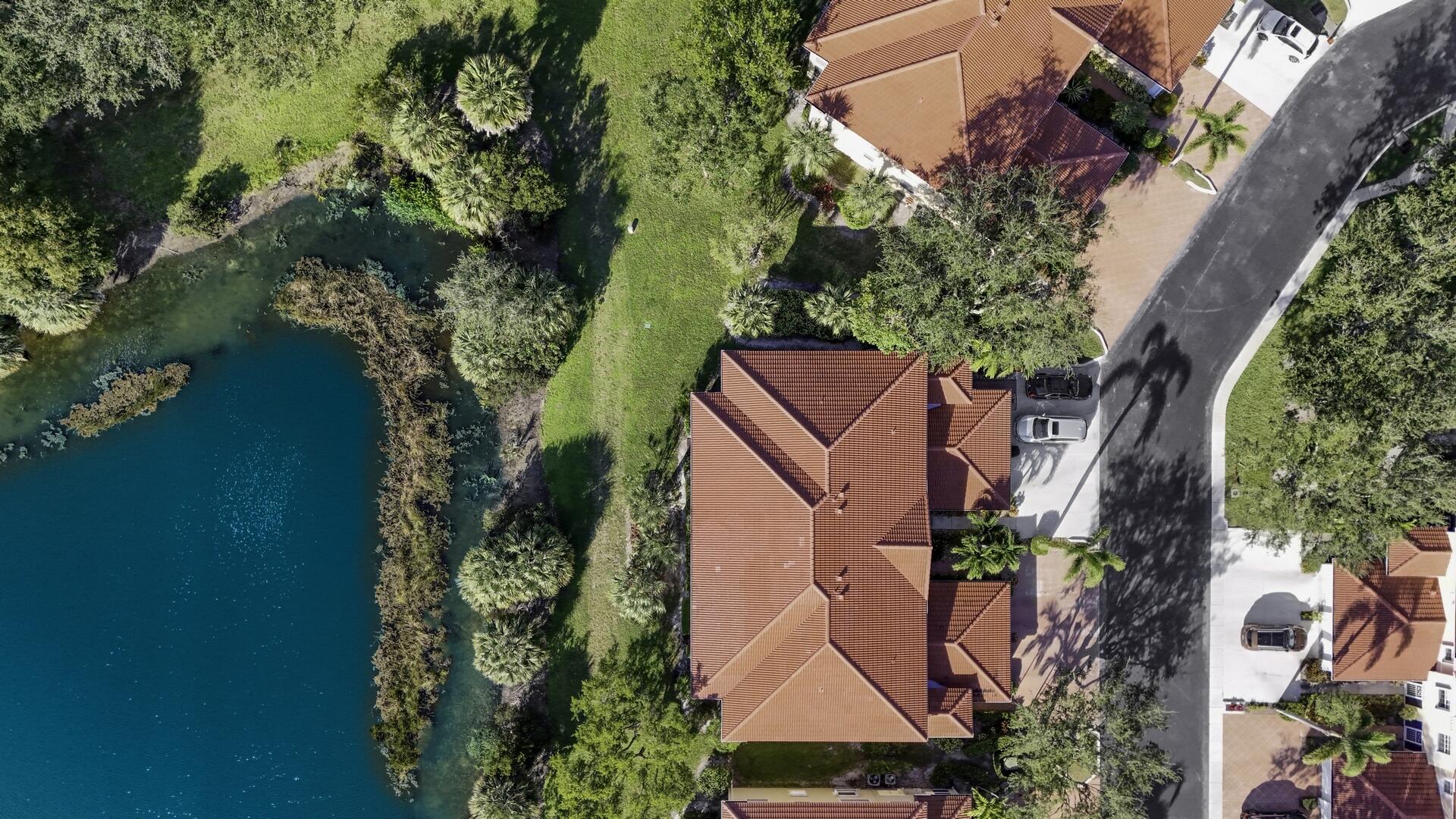 12438 Crystal Pointe Drive, Unit 102 Boynton Beach, FL 33437 - Photo 35 of 39 an aerial view of a house with outdoor space and trees all around