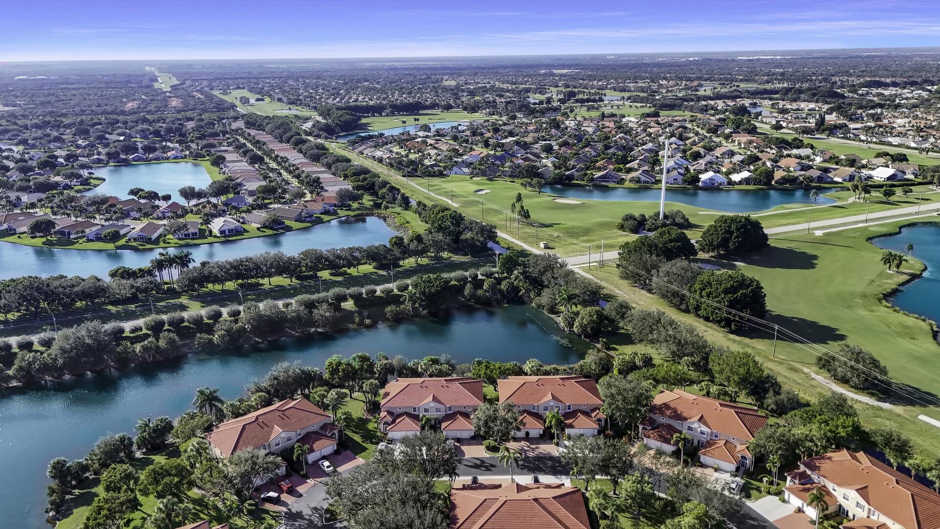 12438 Crystal Pointe Drive, Unit 102 Boynton Beach, FL 33437 - Photo 37 of 39 an aerial view of a city with lots of residential buildings lake and ocean view