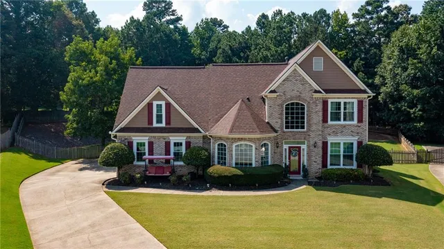 a front view of a house with yard patio and green space