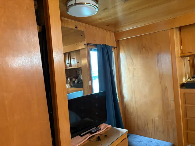 a bedroom with a bed and wooden closet