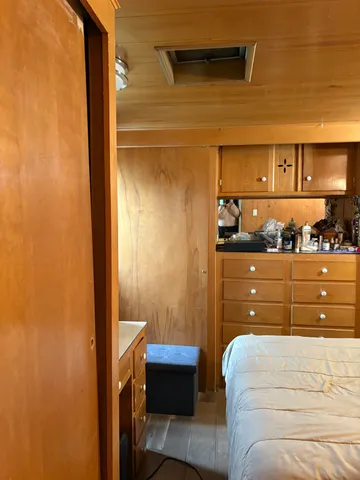 a view of a hallway with wooden shelves